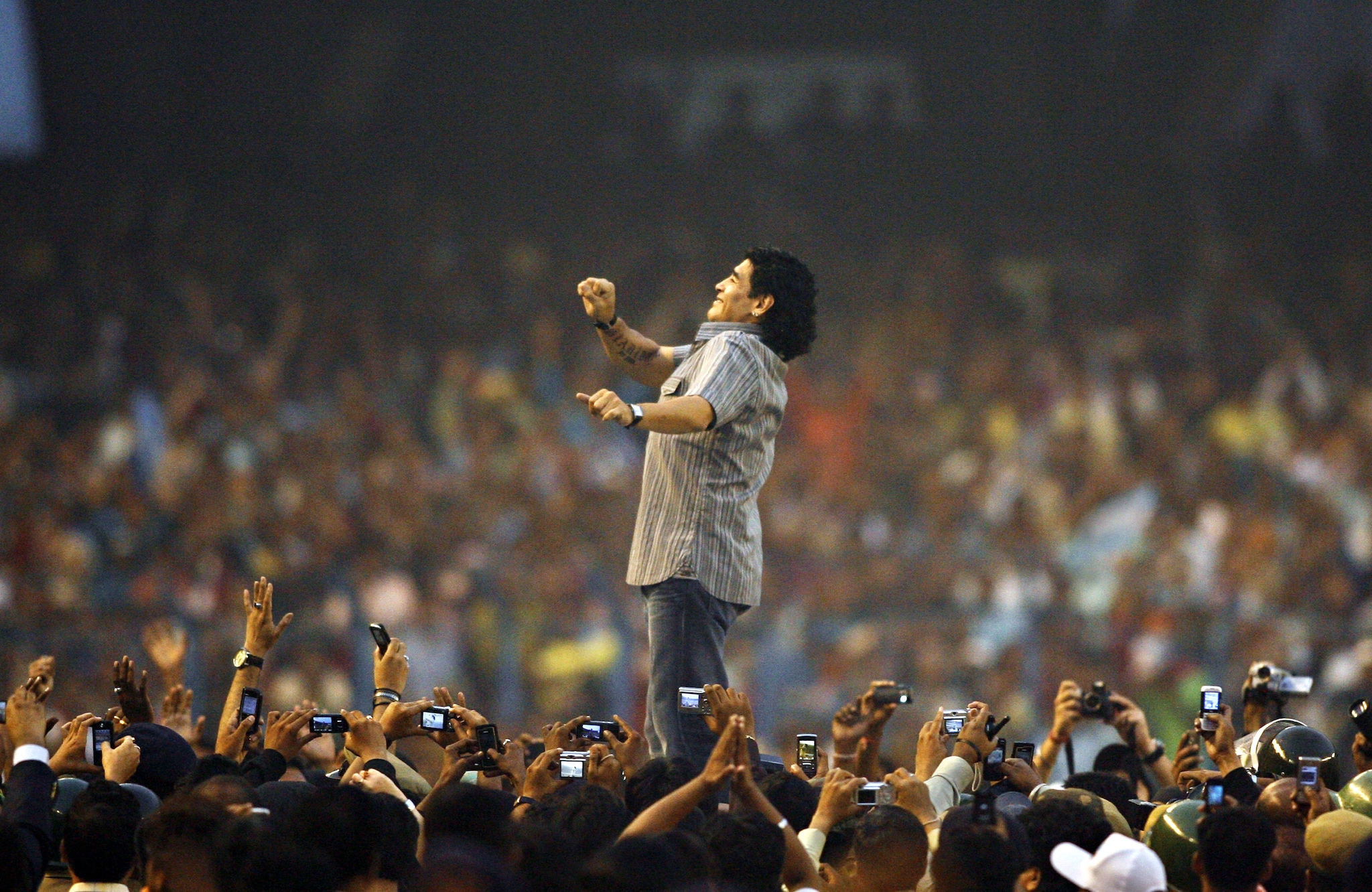  Argentina's national team coach and former football star Diego Armando Maradona gestures as he attends a felicitation programme at Salt Lake Stadium in Kolkata on December 6, 2008. Soccer superstar Diego Maradona said he was greatly touched by the frenzy over his brief visit here and promised to come back to India again in future. (Photo: AFP)