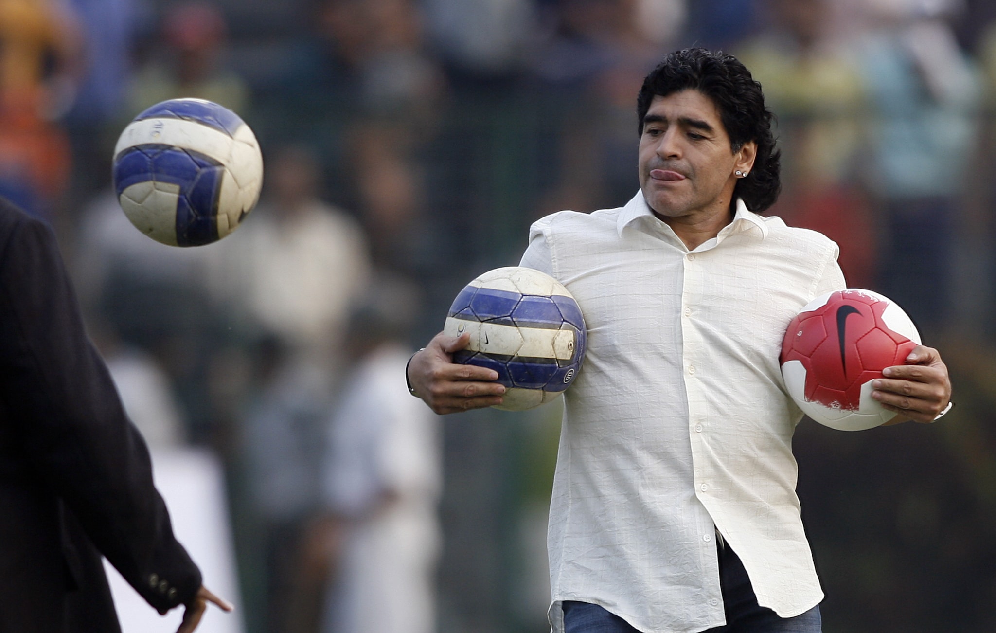  Argentina's national team coach and former soccer star Diego Armando Maradona demonstrates his skills while attending an event at the Mohun Bagan club, in Kolkata on December 7, 2008. Soccer superstar Diego Maradona said he was greatly touched by the frenzy over his brief visit here and promised to come back to India again in future. (Photo: AFP)