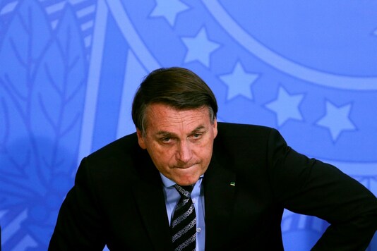 Brazil's President Jair Bolsonaro reacts during a ceremony at the Planalto Palace in Brasilia, Brazi. (Reuters)
