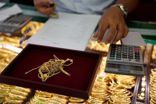 FILE PHOTO: A goldsmith evaluates gold inside a shop i