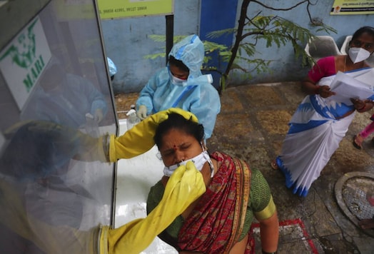 A health worker takes a nasal swab sample at a COVID-19 testing center. (AP) A health worker takes a nasal swab sample at a COVID-19 testing center. (AP)