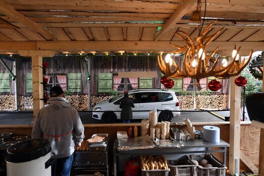 A car stops in front of a booth at a drive-in Christmas market under a large marquee, amid the spread of the coronavirus disease (COVID-19), in Landshut, Germany. (Credit: REUTERS)