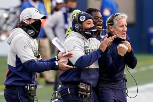 Seattle Seahawks head coach Pete Carroll, right, reacts with running back DeeJay Dallas, second from right, and other coaches after a play against the San Francisco 49ers during the second half of an NFL football game, Sunday, Nov. 1, 2020, in Seattle. (AP Photo/Elaine Thompson)