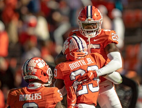 Clemson safety Jalyn Phillips (25) celebrates a defensive stop with cornerback Andrew Booth Jr. (23) during the second half of an NCAA college football game  Saturday, Oct. 31, 2020, in Clemson, S.C. (Josh Morgan/Pool Photo via AP)