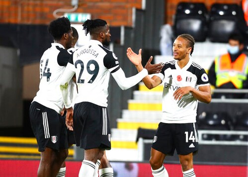 Fulham's Bobby Decordova-Reid, right, celebrates after scoring his side's opening goal during the English Premier League soccer match between Fulham and West Bromwich Albion at Craven Cottage in London, England, Monday, Nov. 2, 2020. (Clive Rose/Pool via AP)