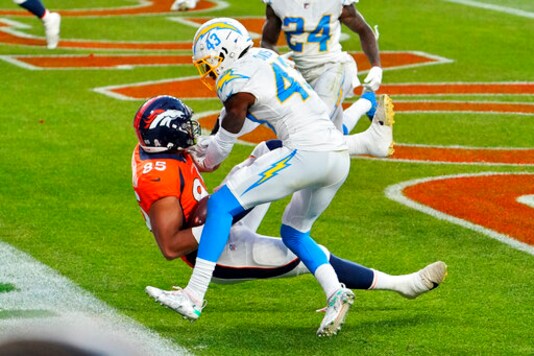 Denver Broncos tight end Albert Okwuegbunam (85) scores a touchdown as Los Angeles Chargers cornerback Michael Davis (43) defends during the second half of an NFL football game, Sunday, Nov. 1, 2020, in Denver. (AP Photo/Jack Dempsey)
