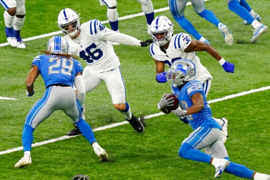 Detroit Lions running back Adrian Peterson, right, rushes during the second half of an NFL football game against the Indianapolis Colts, Sunday, Nov. 1, 2020, in Detroit. (AP Photo/Carlos Osorio)