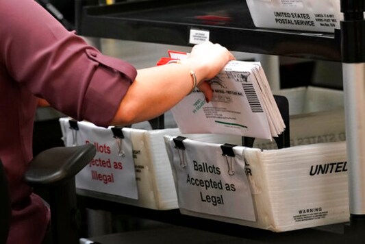 FILE - An election worker sorts vote-by-mail ballots at the Miami-Dade County Board of Elections in Doral, Fla., on Oct, 26, 2020. Television networks are adding experts in election law to their election night coverage teams so they're prepared to explain legal challenges or irregularities that come up during the vote. (AP Photo/Lynne Sladky, File) FILE - An election worker sorts vote-by-mail ballots at the Miami-Dade County Board of Elections in Doral, Fla., on Oct, 26, 2020. Television networks are adding experts in election law to their election night coverage teams so they're prepared to explain legal challenges or irregularities that come up during the vote. (AP Photo/Lynne Sladky, File)