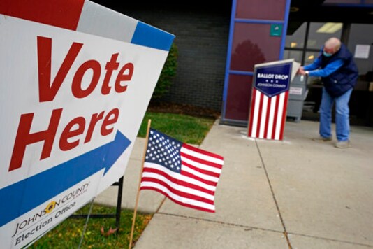 A voter deposits his advance ballot in a dropbox Tuesday, Oct. 20, 2020, in Mission, Kan. (AP Photo/Charlie Riedel, File) A voter deposits his advance ballot in a dropbox Tuesday, Oct. 20, 2020, in Mission, Kan. (AP Photo/Charlie Riedel, File)