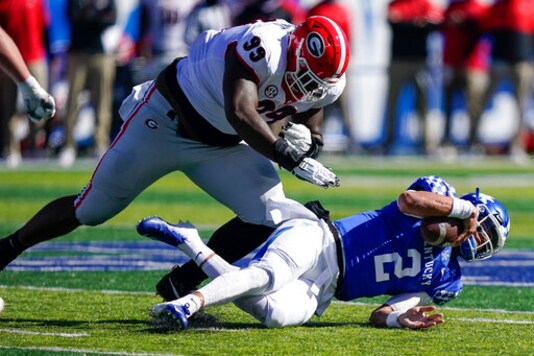 Georgia defensive lineman Jordan Davis (99) tackles Kentucky quarterback Joey Gatewood (2) during the first half of an NCAA college football game, Saturday, Oct. 31, 2020, in Lexington, Ky. (AP Photo/Bryan Woolston)
