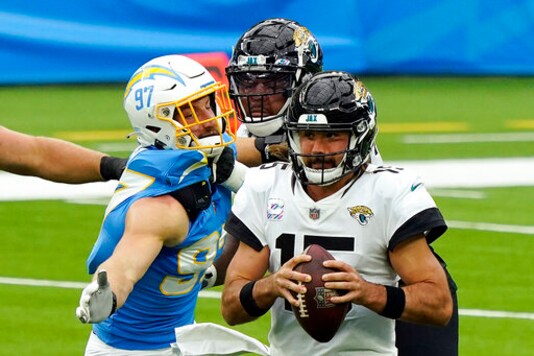 Jacksonville Jaguars quarterback Gardner Minshew, right, is sacked by Los Angeles Chargers defensive end Joey Bosa, left, during the first half of an NFL football game Sunday, Oct. 25, 2020, in Inglewood, Calif. (AP Photo/Alex Gallardo)