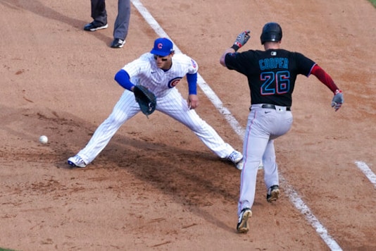 Miami Marlins' Garrett Cooper (26) grounds out as Chicago Cubs first baseman Anthony Rizzo handles the throw during the ninth inning in Game 2 of a National League wild-card baseball series Friday, Oct. 2, 2020, in Chicago. (AP Photo/Nam Y. Huh) Miami Marlins' Garrett Cooper (26) grounds out as Chicago Cubs first baseman Anthony Rizzo handles the throw during the ninth inning in Game 2 of a National League wild-card baseball series Friday, Oct. 2, 2020, in Chicago. (AP Photo/Nam Y. Huh)