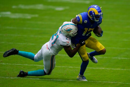 Miami Dolphins free safety Eric Rowe (21) tackles Los Angeles Rams wide receiver Robert Woods (17), during the first half of an NFL football game, Sunday, Nov. 1, 2020, in Miami Gardens, Fla. (AP Photo/Lynne Sladky)