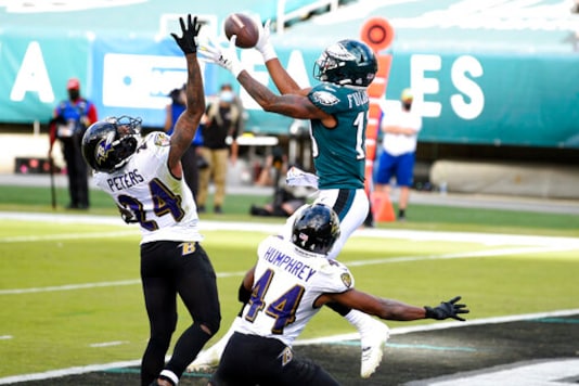 Philadelphia Eagles' Travis Fulgham (13) catches a touchdown pass against Baltimore Ravens' Marlon Humphrey (44) and Marcus Peters (24) during the second half of an NFL football game, Sunday, Oct. 18, 2020, in Philadelphia. (AP Photo/Derik Hamilton) Philadelphia Eagles' Travis Fulgham (13) catches a touchdown pass against Baltimore Ravens' Marlon Humphrey (44) and Marcus Peters (24) during the second half of an NFL football game, Sunday, Oct. 18, 2020, in Philadelphia. (AP Photo/Derik Hamilton)