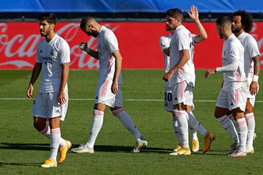 Real Madrid's Karim Benzema, second left, jubilates with teammates after scoring his side's second goal during the Spanish La Liga soccer match between Real Madrid and Huesca at Alfredo di Stefano stadium in Madrid, Spain, Saturday, Oct. 31, 2020. Benzema scored twice in Real Madrid's 4-1 victory. (AP Photo/Manu Fernandez)