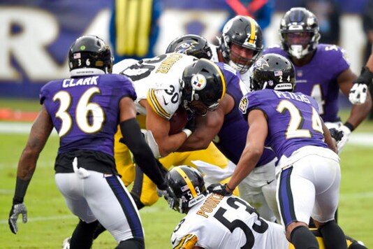 Pittsburgh Steelers running back James Conner (30) pushes in to score on a touchdown run against the Baltimore Ravens during the second half of an NFL football game, Sunday, Nov. 1, 2020, in Baltimore. (AP Photo/Gail Burton)
