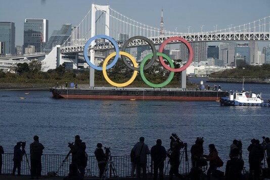 The Olympic Symbol is reinstalled after it was taken down for maintenance ahead of the postponed Tokyo 2020 Olympics in the Odaiba section Tuesday, Dec. 1, 2020, in Tokyo. (Photo Credit: AP Photo/Eugene Hoshiko)