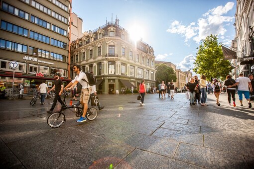 Oslo, Norway - July 20, 2015: Busy street in Oslo, Norway. People walking on the street in city center, backlit shot