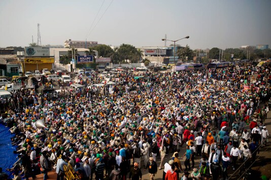 Farmers listen to a speaker as they block a major highway during a protest against new farm laws at the Delhi-Haryana border, on December 1, 2020. (AP Photo/Altaf Qadri)