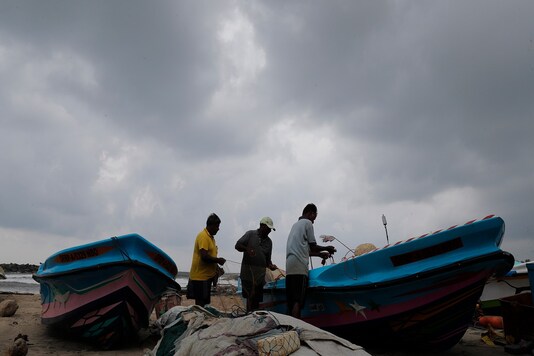 Colombo:Sri Lankan fishermen arrange their accessories on the beach as they prepare for cyclonic storm 'Burevi