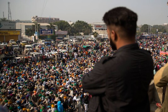 Farmers listen to a speaker during the protest against new farm laws at the Delhi-Haryana border on December 1, 2020. (AP Photo/Altaf Qadri)