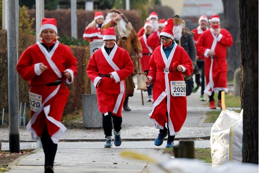 People dressed as Santa Claus race through the streets of Michendorf, near Berlin, during Nikolaus Lauf (Saint Nicholas). REUTERS/Fabrizio Bensch