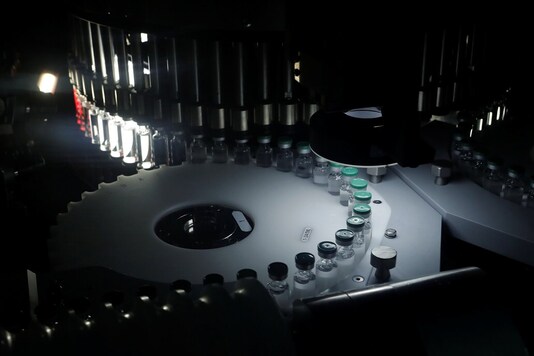 Vials of AstraZeneca's COVISHIELD, coronavirus disease (COVID-19) vaccine are seen inside a visual inspection machine inside a lab at the Serum Institute of India, in Pune, India, 30 November 2020. (Image: REUTERS)