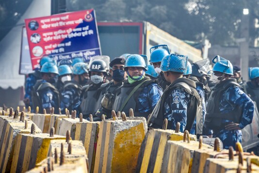 Security personnel stand guard at the Singhu border during ongoing farmers' protest against the Centre's farm laws. (PTI)