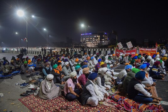 Farmers take part in the ongoing protest against the Centre's farm reform laws, near the  Ghazipur border in New Delhi, Tuesday. (PTI)