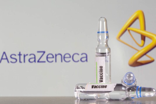 A test tube labeled with the vaccine is seen in front of AstraZeneca logo. (REUTERS/Dado Ruvic/File Photo)