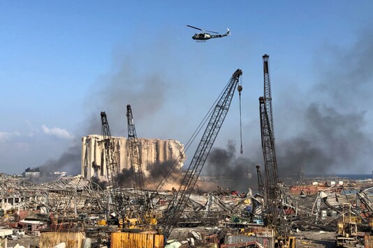 A Lebanese army helicopter flies over the site of the blast in Beirut's port area on August 5, 2020. (REUTERS/Issam Abdallah)