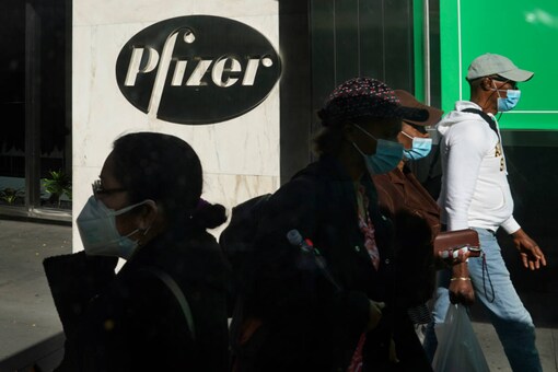 Pedestrians walk past Pfizer world headquarters in New York. (AP Photo/Bebeto Matthews, File)
