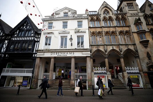 Shoppers walk past a Debenhams store, Browns of Chester, amid the outbreak of the COVID-19 in Chester, Britain. (REUTERS/Phil Noble)