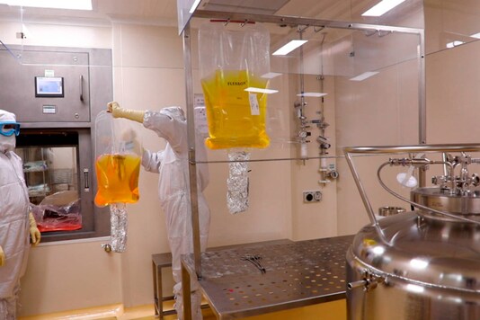 In this undated photograph, employees at the Serum Institute of India, the world’s largest manufacturer of vaccines, work at their facility in Pune, India. (Serum Institute of India via AP)