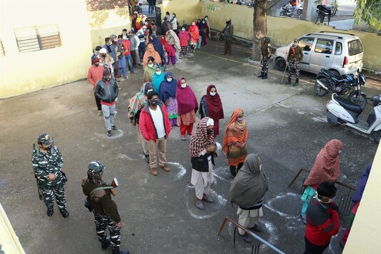 Voters stand in queues to cast their votes for the fifth phase of District Development Council (DDC) elections, at Mandal Village in Jammu, Thursday, Dec. 10, 2020. (PTI Photo)