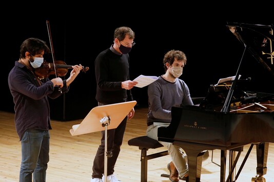 Violinist Yoan Brakha, Director Simon Valastro and Pianist Felix Ramos, members of the Opera de Paris Academy rehearse in masks at the Bastille Opera in Paris.

REUTERS/Charles Platiau