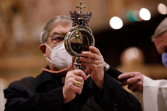Archbishop Cardinal Crescenzio Sepe holds a vial containing the blood of San Gennaro to celebrate the martyred Patron Saint of Naples as faithful wait to see if the saint’s dry blood liquifies in a so-called miracle that means the city will be protected.

REUTERS/Ciro De Luca