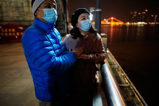 Fang Yushun and his wife, Duan Ling, 36, during a cold winter’s night as they take a walk outside in China's Wuhan.

REUTERS/Aly Song