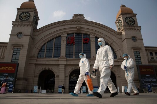 Image for representation. Workers in protective suits walk past the Hankou railway station on the eve of its resuming outbound traffic in Wuhan in central China's Hubei province on Tuesday, April 7, 2020. (AP Photo)