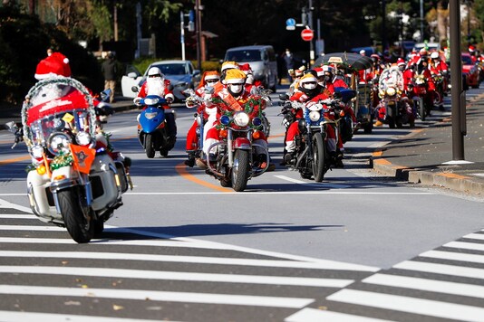 People dressed in Santa Claus costumes ride their motorbikes during Xmas Toy Run parade to rev up the holiday spirit and rally against child abuse, organised by Harley Santa Club in Tokyo.

REUTERS/Issei Kato