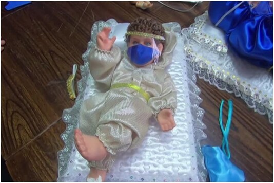 Baby Jesus in hazmat suit and mask 