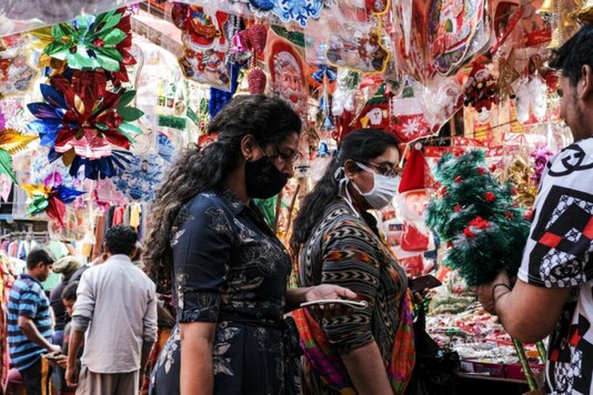 People shop for decorations at a roadside stall ahead of Christmas in Kolkata, India, Friday, Dec. 18, 2020. Although Christians comprise only two percent of the population Christmas is a national holiday and is observed across the country as an occasion to celebrate. (AP Photo/Bikas Das)