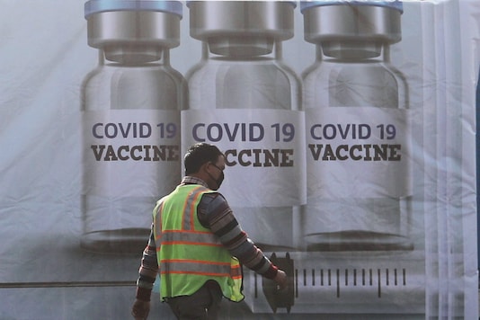 A ground staff walks past a container kept at the Cargo Terminal 2 of the Indira Gandhi International Airport, which according to the officials will be used as a COVID-19 vaccine handling and distribution centre. (Reuters)