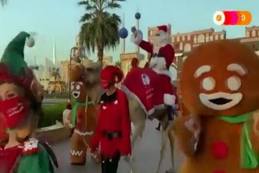 The video shows Santa riding through the streets of the Global Village, surrounded by a group of gingerbread men. (Credit: REUTERS/Twitter)