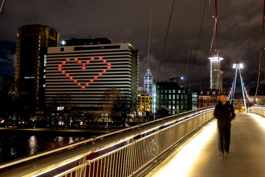 A hotel with lights in some rooms on to form a heart near the buildings of the banking district in in Frankfurt, Germany, Wednesday, Dec. 23, 2020 as Germany continues its second lockdown to avoid the further outspread of the coronavirus. (AP Photo/Michael Probst)
