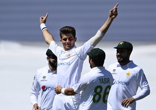 Pakistan bowler Shaheen Afridi celebrates with teammates after taking the early wicket of New Zealand's Tom Latham on day one of the first cricket test between Pakistan and New Zealand at Bay Oval, Mount Maunganui, New Zealand, Saturday, Dec. 26, 2020. (Andrew Cornaga/Photosport via AP)