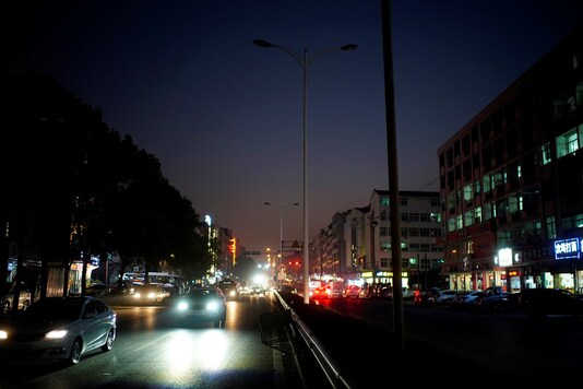 Cars drive on a street with the lighting system partially off in Yiwu, Zhejiang province, China.

REUTERS/Aly Song - RC2GTK9DOGW5