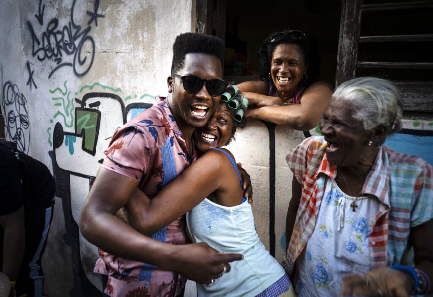  Cuban singer Cimafunk hugs a woman during a music conga through the streets of Cuba's Old Havana neighbourhood during the 35th Havana International Jazz Festival. (Image: AP)