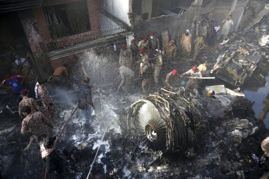  Rescue workers and local residents search for survivors in the wreckage of a plane that crashed with nearly 100 people on board in a residential area of Karachi, Pakistan. (Image: AP)