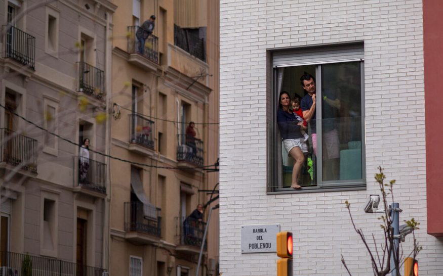  People stand in their balconies during nationwide confinement to counter the coronavirus in Barcelona, Spain. (Image: AP)